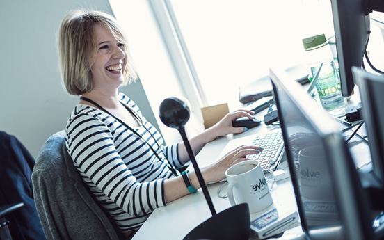 Woman smiling using technology